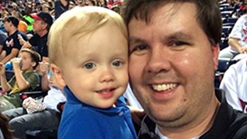 Justin Ross Harris and his son, Cooper, photographed at a ball game. Police say Harris purposely left Cooper in a sweltering car to die on June 18, 2014. His lawyers have said the child's death was an accident.