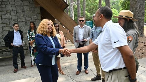 U.S. Rep. Lucy McBath (left) is greeted by a guest as she arrives for an event that intended to educate members of the public about implementation of the Chattahoochee River Act at Jones Bridge Park, Thursday, August 3, 2023, in Peachtree Corners. The Chattahoochee River Act was sponsored by Rep. Lucy McBath and Sen. Jon Ossoff in the House and Senate. (Hyosub Shin / Hyosub.Shin@ajc.com)
