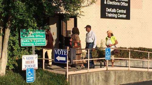 Voters walk into the DeKalb County Voter Registration and Elections Office off Memorial Drive on Oct. 17 as early voting begins. KENT JOHNSON / KDJOHNSON@AJC.COM