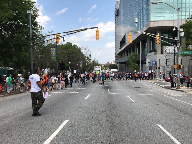 Protesters are now heading back downtown, toward the location of Karen Handel's fundraiser where President Donald is to speak later today.