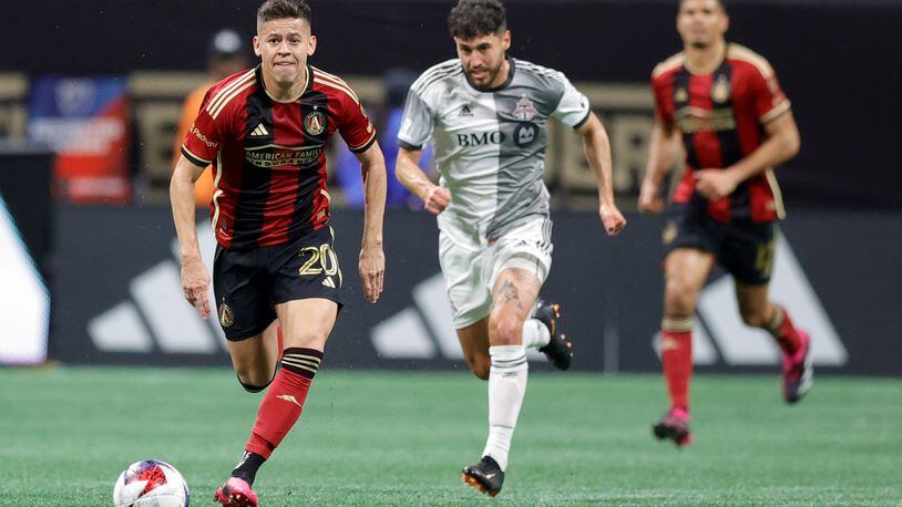 Atlanta United midfielder Matheus Rossetto drives down field past Toronto FC midfielder Jonathan Osorio during the second half of an MLS soccer match, Saturday, March 4, 2023, in Atlanta.