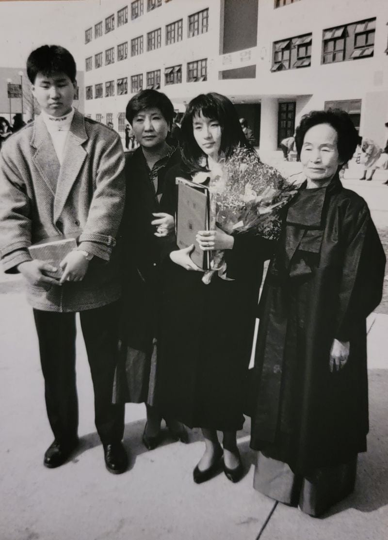 Joining Jiyeon Lee (with flowers) at her high school graduation are her grandmother, Gi Hyun Kim, (far right), mother and brother.
Courtesy of Jiyeon Lee