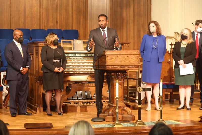Atlanta Mayor Andre Dickens (center) and Rev. Jasmine R. Smothers (center left) spoke at Atlanta First United Methodist Church on Feb. 23, 2022, about affordable housing efforts by faith-based organizations. Miguel Martinez for The Atlanta Journal-Constitution 
