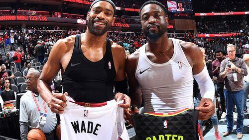 The Hawks' Vince Carter (left) and the Heat's Dewayne Wade show off their jersey exchange following a game in Miami earlier this season. Photo by Scott Cunningham/Getty Images