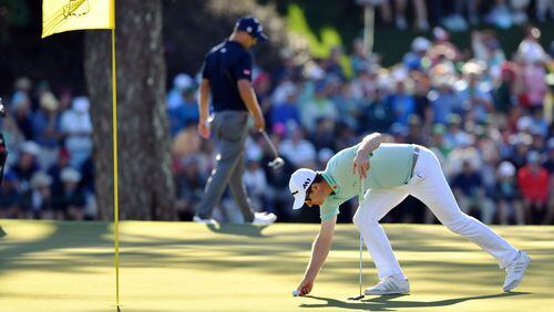 Justin Rose retrieves his ball after a par on the 15th green Saturday in in the third round of the 81st Masters tournament at the Augusta National Golf Club, Saturday, April 8, 2017. BRANT SANDERLIN / SPECIAL