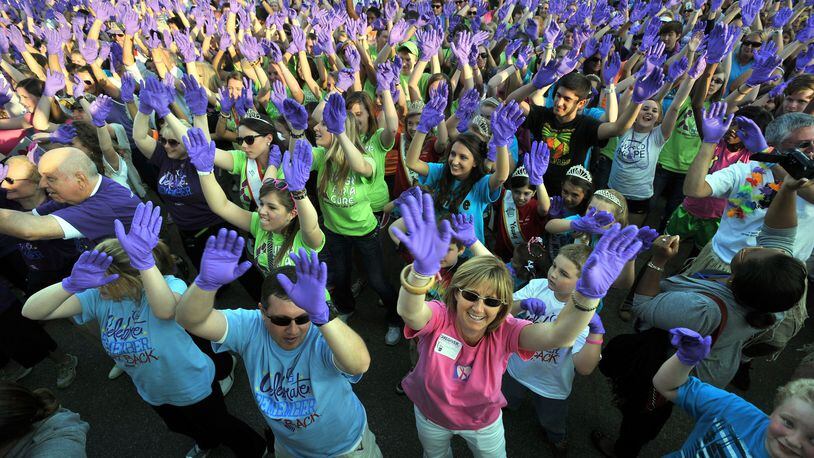 In this file photo, thousands of participants perform the Purple Glove Dance, which was made in an effort to raise awareness and donations for support of the Relay for Life at the Gwinnett County Fairgrounds. HYOSUB SHIN / HSHIN@AJC.COM