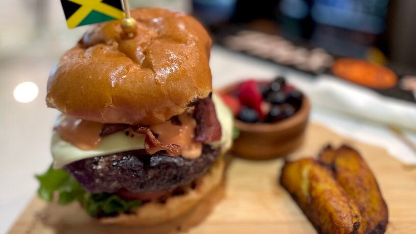 The Hangover Brunch burger comes with a fried egg and thick, crisp bacon, and is infused with Jamaican jerk, as well. Angela Hansberger for The Atlanta Journal-Constitution