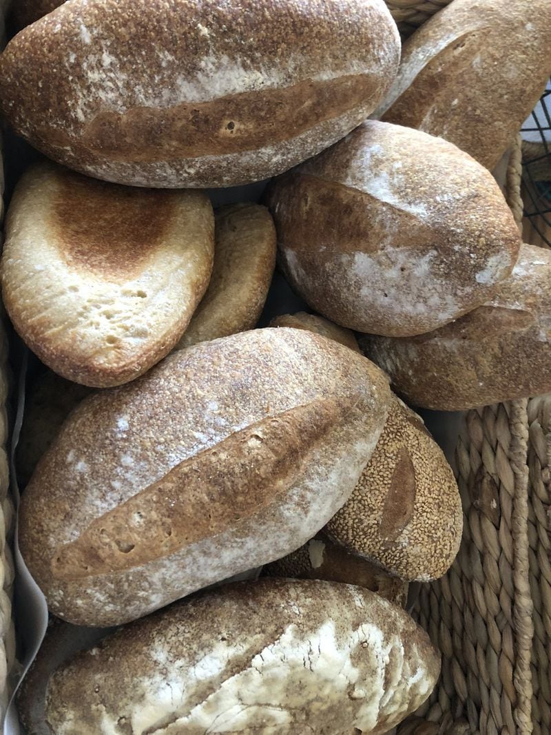 Loaves of seeded wheat multigrain bread and sesame sourdough are two of the standard offerings of Just Bakery of Atlanta. CONTRIBUTED BY JUST BAKERY OF ATLANTA