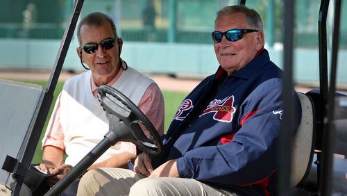 Feb. 20, 2012- LAKE BUENA VISTA, FL: Atlanta Braves president John Schuerholz, left, talks with former manager Bobby Cox as they watch the first day of pitchers and catchers workouts at Champion Stadium in the ESPN Wide World of Sports Complex Monday morning in Lake Buena Vista, Fl., Feb. 20, 2012. Jason Getz jgetz@ajc.com