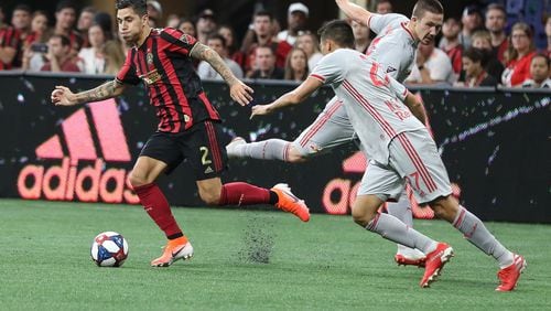 Atlanta United defender Franco Escobar (2) moves the ball past New York City Red Bulls players during the first half of a MLS game on Sunday, July 7, 2019, in Atlanta. Branden Camp/SPECIAL