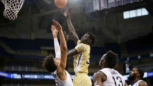 Georgia Tech forward Abdoulaye Gueye (34) goes up shot over Pittsburgh forward Kene Chukwuka (15) during the first half of an NCAA college basketball game, Saturday, Jan. 13, 2018, in Pittsburgh. (AP Photo/Jared Wickerham)