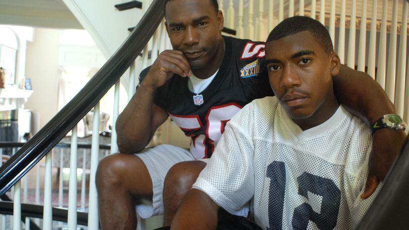 Former Falcons linebacker Jessie Tuggle (left) with his son Justin Tuggle, when Justin was a senior and quarterback at Northview High School. Justin Tuggle now plays with the Houston Texans. (RENEE BROCK/AJC file)