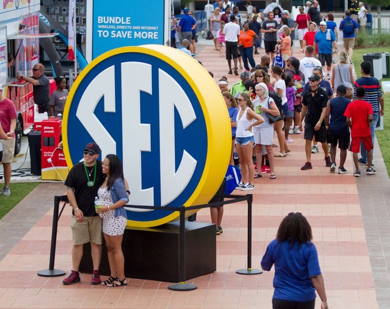 People file past a large SEC sign during the inaugural SEC Summerfest in Centennial Olympic Park on Sunday, July 15, 2018. This free event was a first-of-its-kind and was being held in conjunction with the SEC's annual football media days. (Photo: STEVE SCHAEFER / SPECIAL TO THE AJC)