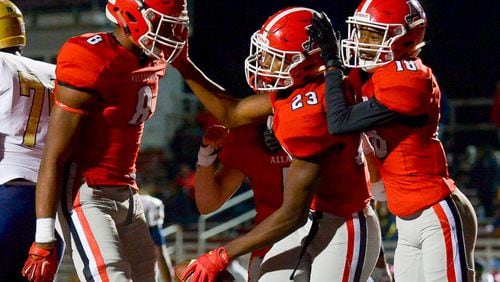 Allatoona junior RB T.J. Carr (23) celebrate his touchdown with senior TE Jaylan Williams (8) and senior WR Jonathan Davis (18) late in the fourth quarter of their game Friday, October 12, 2018 at Allatoona High School. PHOTO/Daniel Varnado