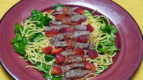 Stawberry-Sauced Steak with Sesame Noodles and Spinach. (Linda Gassenheimer/TNS)