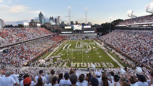 Georgia Tech’s Ramblin’ Wreck leads the band, cheerleaders, Buzz, players, and coaches before the start of the Georgia Tech home game against the Clemson Tigers at Bobby Dodd Stadium on Thursday, September 22, 2016. HYOSUB SHIN / HSHIN@AJC.COM