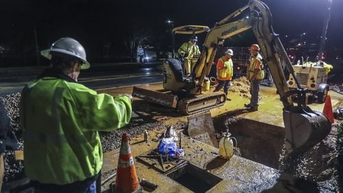 The City of Atlanta is asking voters in upcoming May election to approve a longstanding one percent sales tax to fund water and sewer projects that are mandated under a federal consent decree. Shown here are city work crews repairing a water main break on Lenox Road in January. JOHN SPINK/JSPINK@AJC.COM
