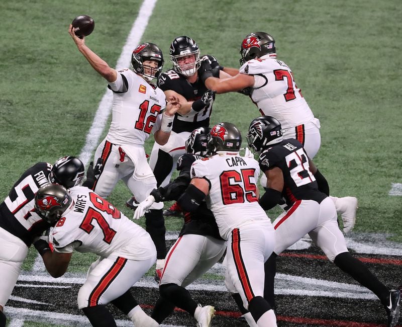 Tampa Bay quarterback Tom Brady throws under pressure from the Falcons during fourth-quarter comeback Sunday, Dec. 20, 2020, in Atlanta. The Buccaneers won 31-27. (Curtis Compton / Curtis.Compton@ajc.com)
