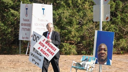 Attorney Daniel Kolber holds signs that read ‚"Don't Kill Willie Pye" and "Two Wrongs Don't Make a right", across from Georgia Diagnostic Prison in Jackson, Ga. where Willie James Pye, was executed on Wednesday, March 20, 2024. (Natrice Miller/ Natrice.miller@ajc.com)