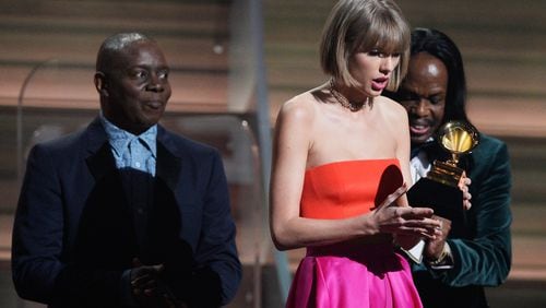 LOS ANGELES, CA - FEBRUARY 15: Singer Taylor Swift (C) accepts the Album of the Year award for "1989" onstage from musicians Philip Bailey (L) and Verdine White of Earth, Wind & Fire during The 58th GRAMMY Awards at Staples Center on February 15, 2016 in Los Angeles, California. (Photo by Kevork Djansezian/Getty Images for NARAS)
