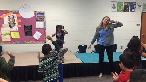 Graves Elementary School teacher Sarah Jones leads a kindergarten class in a dance exercise before acting out “The Tortoise and The Hare.” “When we move our body, we do good things for our brain,” she told the students. ERIC STIRGUS / ESTIRGUS@AJC.COM