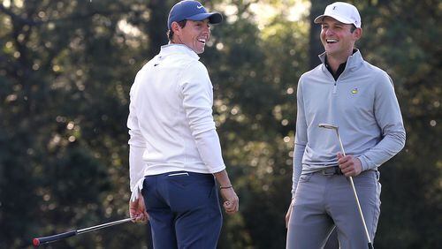 One day he's fighting fires, another Matt Parziale, right, is laughing it up with Rory McIlroy during a Masters practice round. (Curtis Compton/ccompton@ajc.com)