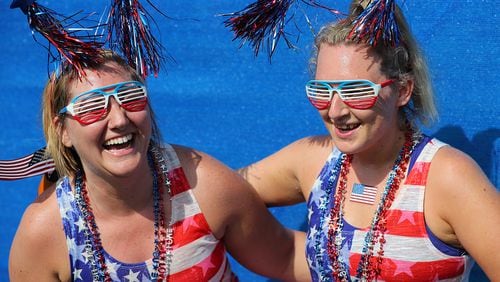 Bethany Bearden (left) and Kimberly Robinson, Gainesville, celebrate after finishing the 48th running of the AJC Peachtree Road Race on Tuesday, July 4, 2017, in Atlanta.    Curtis Compton/ccompton@ajc.com