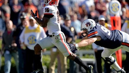 Georgia's Isaiah McKenzie returns a punt for a touchdown against Auburn in 2015.  BRANT SANDERLIN/BSANDERLIN@AJC.COM