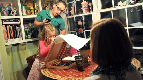 Max Waterhouse, 17, takes a peek as his sister Violet, 8, draws a portrait of Lindsay Rutledge (foreground) of Decatur, a friend of the family, at their home in Decatur on Friday, Jan. 25, 2013.