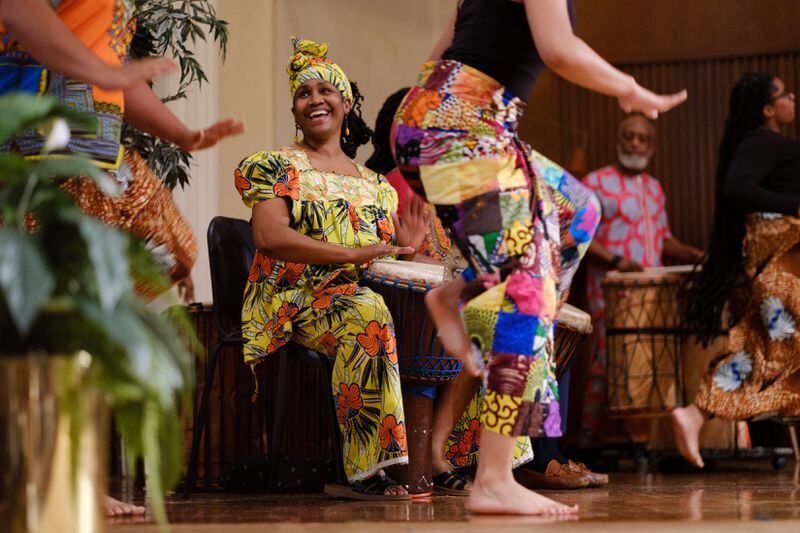 Omelika Kuumba (center) is seen playing the djembe drum at Spelman College in Atlanta on Wednesday, April 27, 2022.   (Arvin Temkar / arvin.temkar@ajc.com)