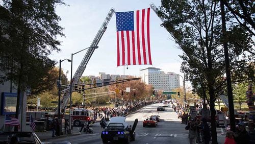 A large flag hangs over Baker Street during The Georgia Veterans Day Parade in downtown Atlanta Saturday, November 11, 2017.