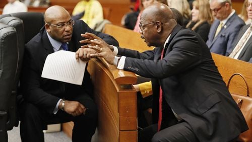 Chief Assistant District Attorney Clint Rucker (left) talks with Fulton County District Attorney Paul Howard, Jr. during the Tex McIver murder trial at the Fulton County Courthouse. Bob Andres bandres@ajc.com AJC FILE PHOTO