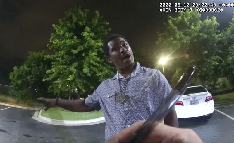 This screen grab taken from body camera video provided by the Atlanta Police Department shows Rayshard Brooks speaking with Officer Garrett Rolfe in the parking lot of a Wendy's restaurant, late Friday, June 12, 2020, in Atlanta. Rolfe has been fired following the fatal shooting of Brooks and a second officer has been placed on administrative duty.