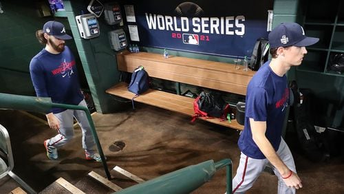 Braves pitchers Ian Anderson (left) and Max Fried walk through the dugout arriving for team practice Monday, Oct. 25, 2021, at Minute Maid Park the day before playing the Astros in Game 1 of the World Series in Houston. (Curtis Compton / Curtis.Compton@ajc.com)