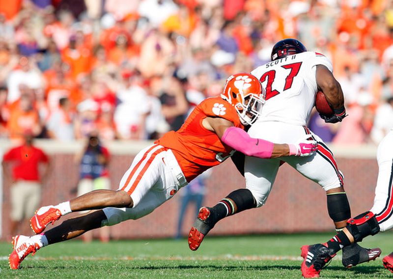 Vic Beasley #3 of the Clemson Tigers makes a tackle on L.J. Scott #27 of the Louisville Cardinals during the game at Memorial Stadium on October 11, 2014 in Clemson, South Carolina. (October 10, 2014 - Source: Tyler Smith/Getty Images North America)