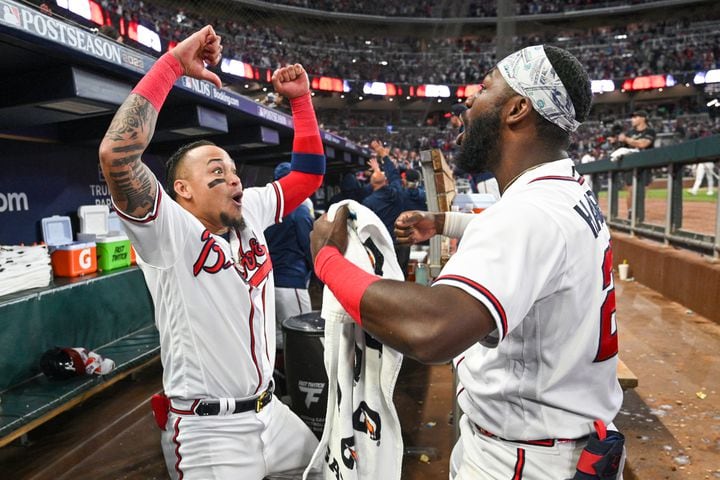 Atlanta Braves’ Orlando Arcia (11) and Michael Harris II (23) celebrate after Austin Riley’s two-run home run against the Philadelphia Phillies during the eighth inning of NLDS Game 2 in Atlanta on Monday, Oct. 9, 2023.   (Hyosub Shin / Hyosub.Shin@ajc.com)