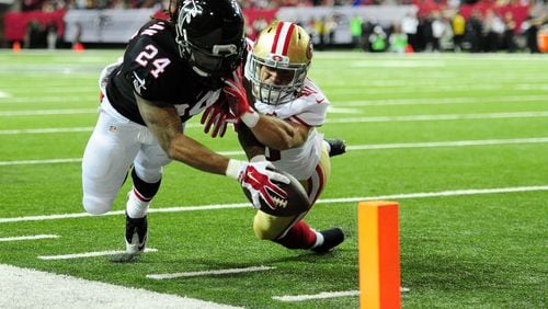 A Devonta Freeman #24 of the Atlanta Falcons fails to reach the pylon against Vinnie Sunseri #40 of the San Francisco 49ers during the first half at the Georgia Dome on December 18, 2016 in Atlanta, Georgia. (Photo by Scott Cunningham/Getty Images)
