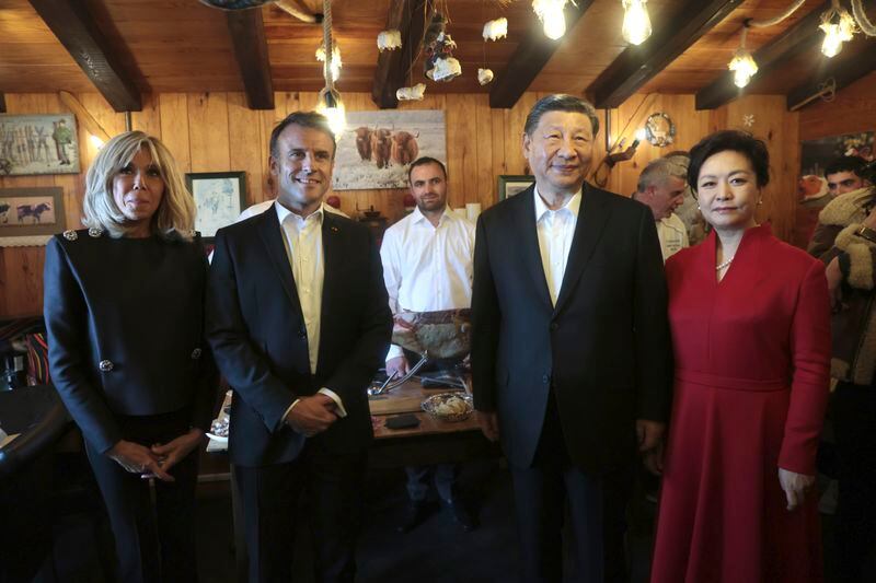 Chinese President Xi Jinping and his wife Peng Liyuan, right, French President Emmanuel Macron and his wife Brigitte Macron, left, pose in a restaurant, Tuesday, May 7, 2024 at the Tourmalet pass, in the Pyrenees mountains. French president is hosting China's leader at a remote mountain pass in the Pyrenees for private meetings, after a high-stakes state visit in Paris dominated by trade disputes and Russia's war in Ukraine. French President Emmanuel Macron made a point of inviting Chinese President Xi Jinping to the Tourmalet Pass near the Spanish border, where Macron spent time as a child visiting his grandmother. (AP Photo/Aurelien Morissard, Pool)