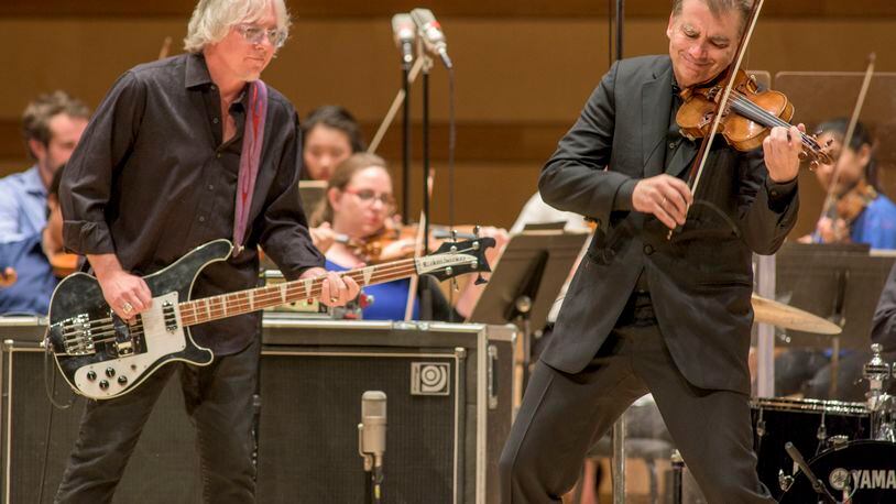 Mike Mills (left) and Robert McDuffie perform Mill's concerto.