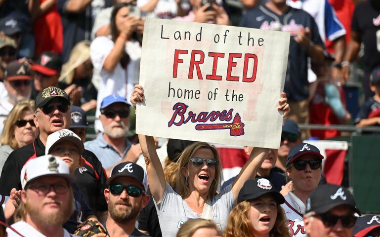Fans cheer on the Braves as they take the field for game one of the baseball playoff series between the Braves and the Phillies at Truist Park in Atlanta on Tuesday, October 11, 2022. (Hyosub Shin / Hyosub.Shin@ajc.com)