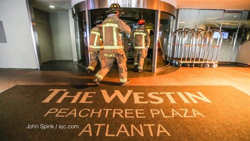 Atlanta firefighters are shown responding to a June 2020 fire at the Westin Peachtree Plaza. Crews were again called to the downtown Atlanta hotel Sunday after eight people became trapped in an elevator. (JOHN SPINK / JSPINK@AJC.COM)
