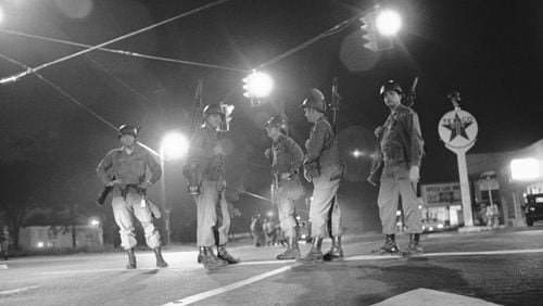 Georgia National Guard troops an intersection at the edge of the riot-torn area of town in Augusta, Ga., May 12, 1970. The guardsmen were called to duty when roving gangs began to riot, setting fire to over fifty buildings and looting many stores. (AP Photo/Joe Holloway, Jr.)