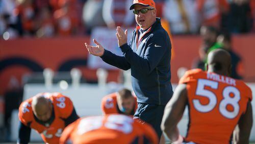 FILE: JANUARY 11, 2014: According to reports, the Denver Broncos and John Fox have mutually agreed on Fox's departure from the ream after four years as head coach just days after the Broncos were eliminated from the 2014 NFL Playoffs. DENVER, CO - DECEMBER 7: Head coach John Fox of the Denver Broncos walks the field as players stretch before a game against the Buffalo Bills at Sports Authority Field at Mile High on December 7, 2014 in Denver, Colorado. (Photo by Dustin Bradford/Getty Images) John Fox, fired by Denver Monday, led both the Broncos and Carolina to Super Bowl appearances. (Getty Images)