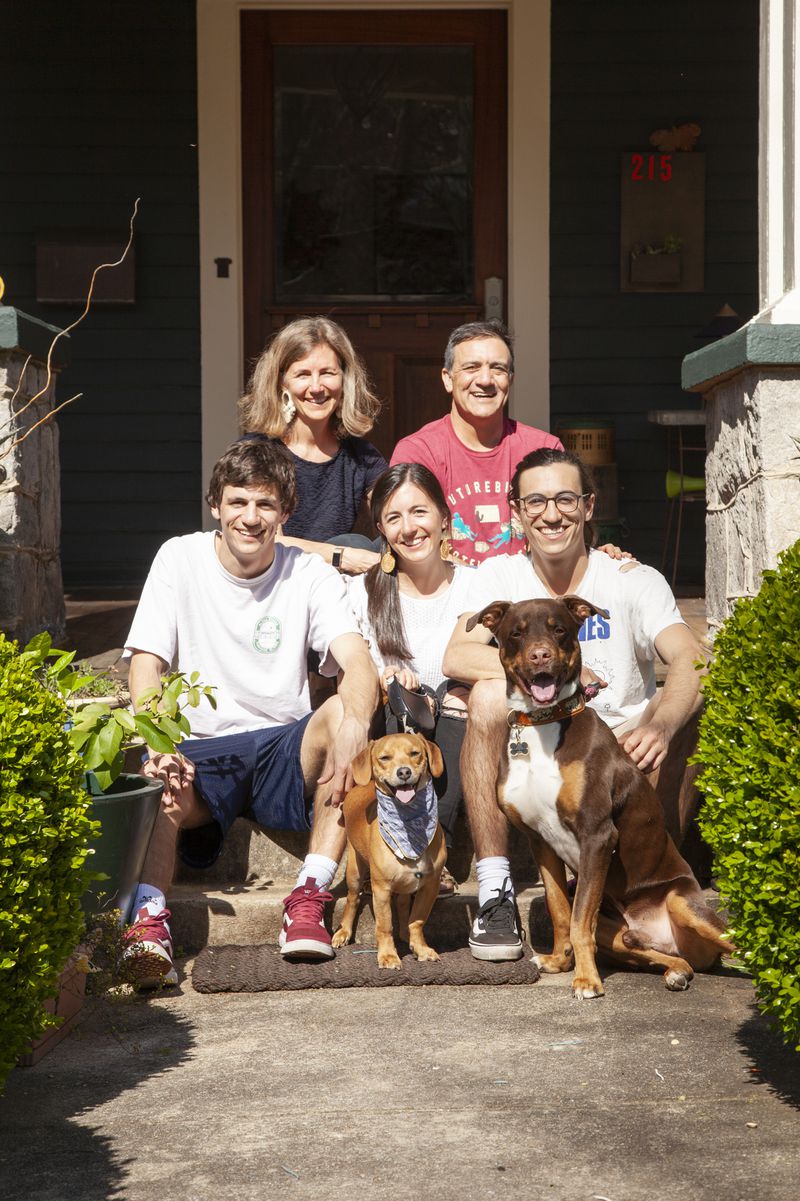 Saleem and Lisa Malik purchased their Inman Park American Foursquare in 2014. Their children are (left to right) Hobie, 21, Campbell, 26, and Jason, 23, with dogs Wally (left) and Lewis (right). Lisa is a speech-language pathologist and Saleem is an obstetrician/gynecologist.