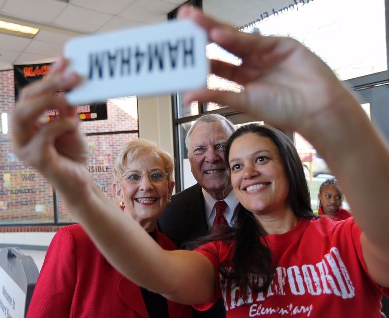 Atlanta Public Schools Superintendent Meria Carstarphen takes a selfie with then-Gov. Nathan Deal and first lady Sandra Deal at Whitefoord Elementary School. BEN GRAY/AJC FILE PHOTO