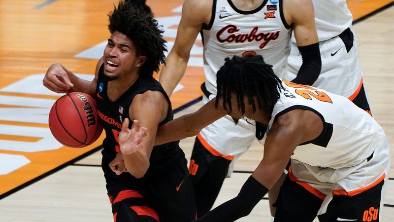 Oregon State guard Ethan Thompson (5) is fouled by Oklahoma State guard Keylan Boone (20) during the second half of their second-round NCAA Tournament game Sunday, March 21, 2021, at Hinkle Fieldhouse in Indianapolis. (Paul Sancya/AP)
