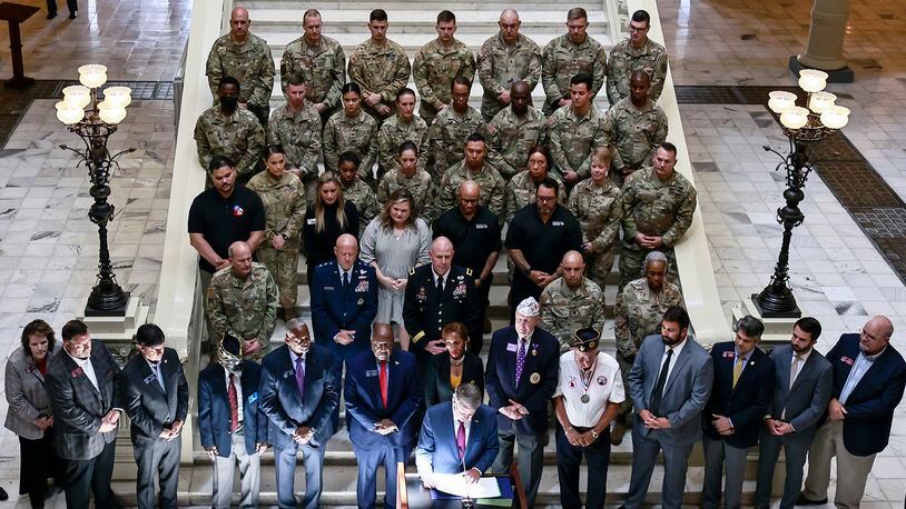 Surrounded by active military and veterans, Gov. Brian Kemp announces a new partnership with SK Battery to connect veterans with jobs on Wednesday, July 20, 2022 at the State Capitol. (Natrice Miller/natrice.miller@ajc.com)