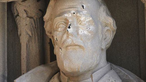 In this Aug. 17, 2017 photo, the defaced Gen. Robert E. Lee statue stands at the Duke Chapel in Durham, N.C. Duke University removed the statue Aug. 19, days after it was vandalized amid a national debate about monuments to the Confederacy. The university said it removed the carved limestone likeness early Saturday morning from where it had stood among 10 historical figures depicted in the entryway (Bernard Thomas/The Herald-Sun via AP)