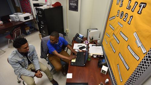 Valencia Dennis, student support coach, talks to Paul Askew, 17, during their Target 2021 program session at Maynard Jackson High School on Wednesday, February 7, 2018. HYOSUB SHIN / HSHIN@AJC.COM