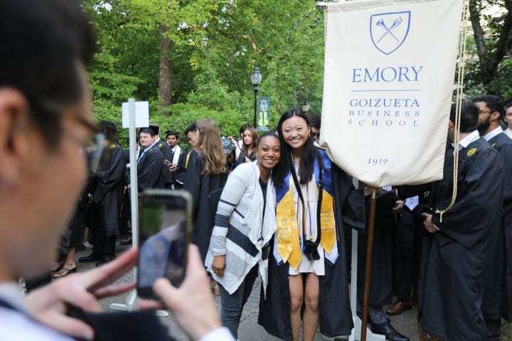 Andrew Johnson takes a photo of Danielle Mitchel and Michelle He, as they prepare to march the procession of the ceremony during Emory University’s 2022 Commencement on Monday, May 9, 2022. Miguel Martinez /miguel.martinezjimenez@ajc.com